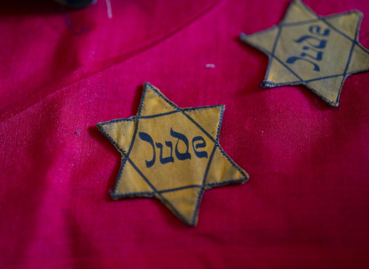 Two fabric yellow stars of David embroidered with the German word "Jude," or "Jew."