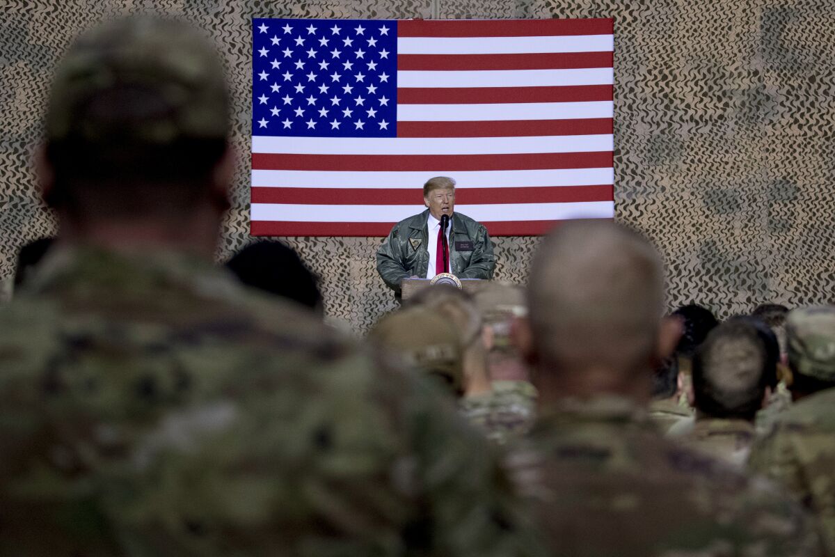 FILE - In this Dec. 26, 2018, file photo, President Donald Trump speaks to members of the military in Iraq.