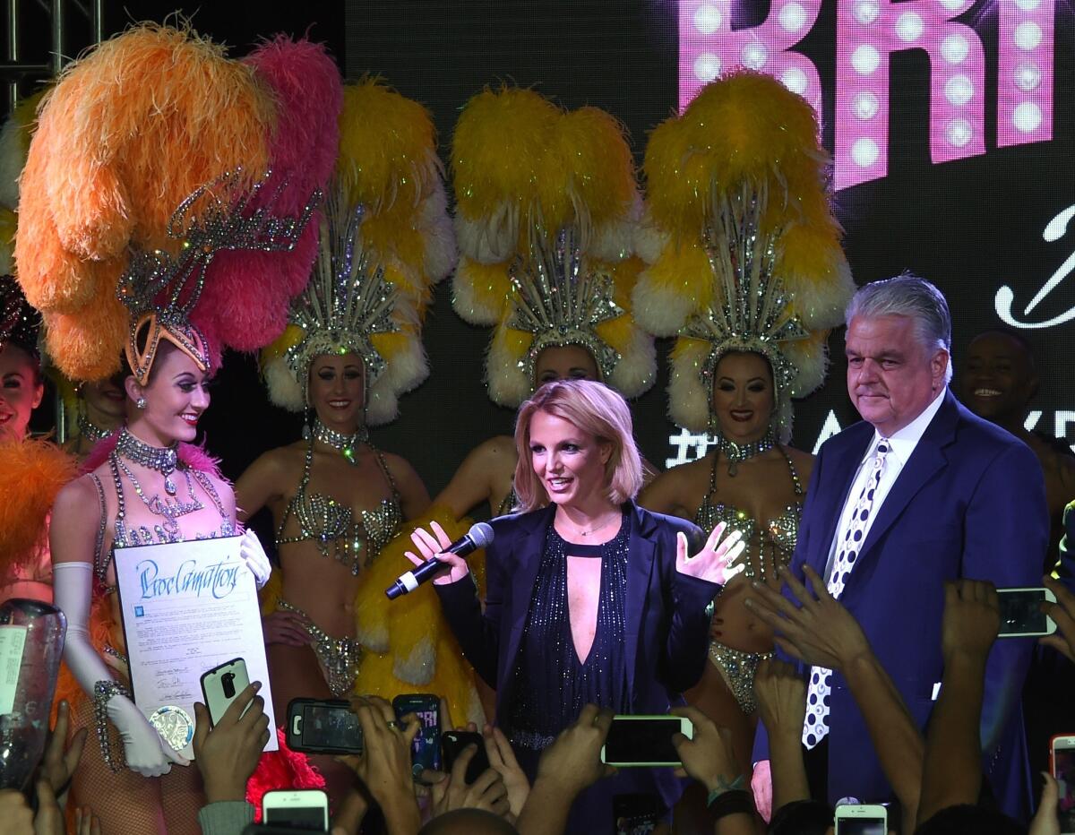 Singer Britney Spears, center, Clark County Commissioner Steve Sisolak, right, and cast members from the "Jubilee" attend a "Britney Day" event to celebrate Spears' Las Vegas residency show "Britney: Piece of Me" on Nov. 5.