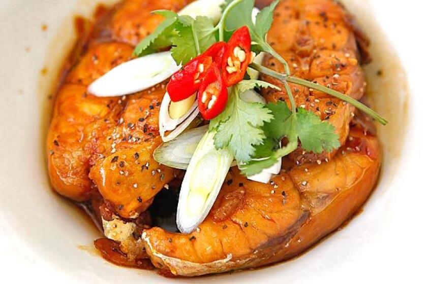 Red-cooked catfish is simmered in a mahogany-colored caramelized fish sauce.