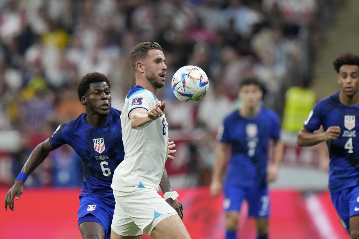 England's Jordan Henderson controls the ball next to the United States' Yunus Musah (6) in the World Cup on Nov. 25, 2022.