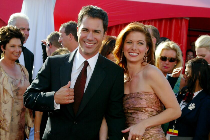 Actors Eric McCormack and Debra Messing attend the 55th Primetime Emmy Awards at the Shrine Auditorium September 21, 2003