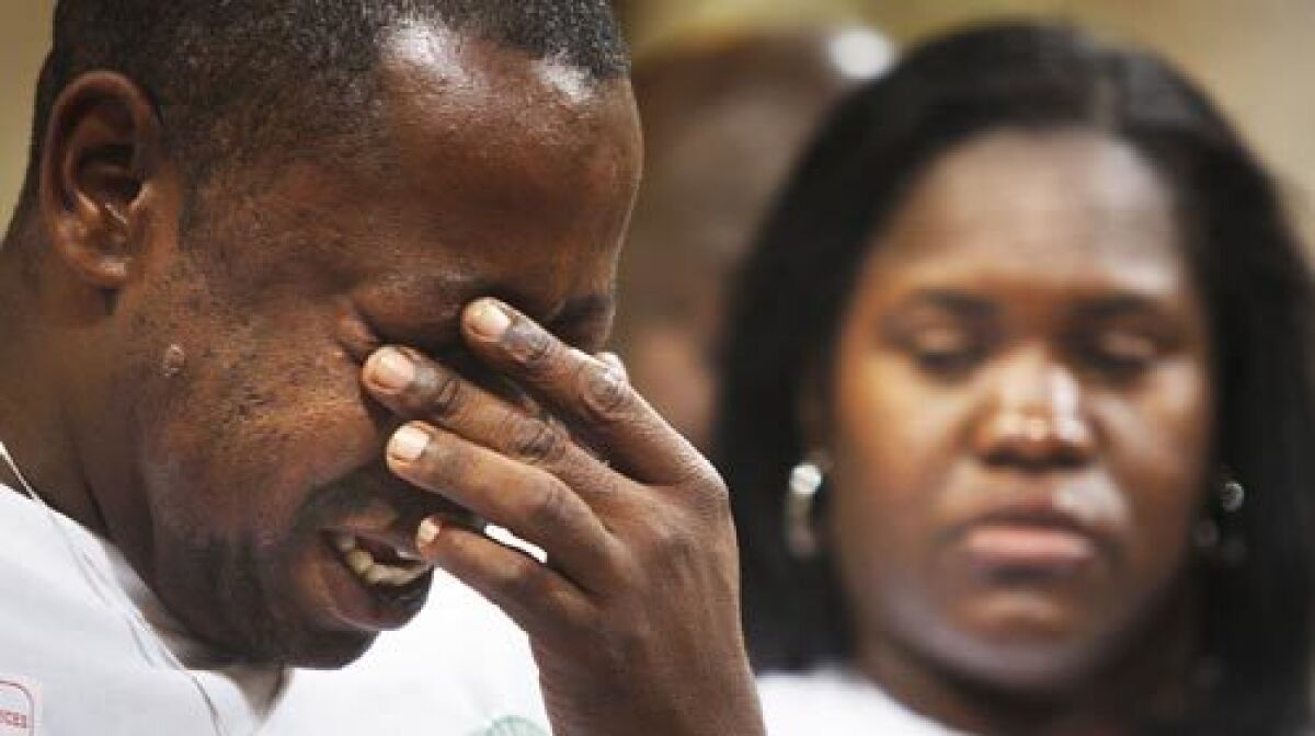 Jamiel Shaw Sr. weeps while standing with his wife Anita Shaw before the Los Angeles City Council Tuesday.