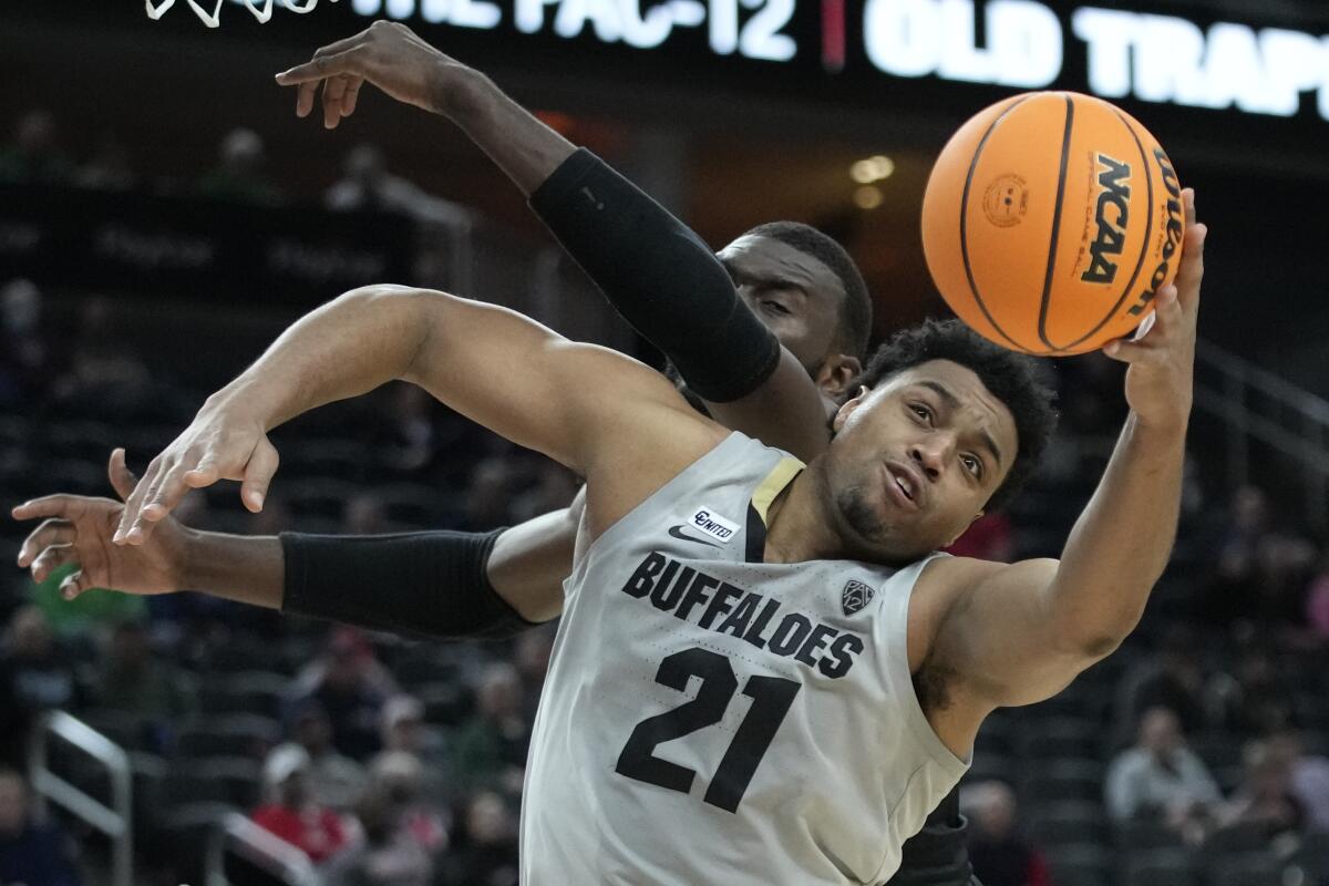 Colorado's Evan Battey grabs a rebound against Oregon.