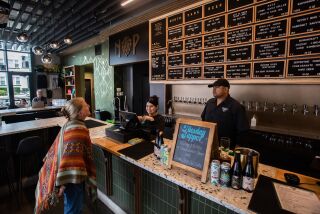San Diego, CA - May 23: Customer Cyndy McBride orders from bartenders Sofia Garcia and Manuel Baez at North Park Beer in Bankers Hill in San Diego, CA on Tuesday, May 23, 2023. The taproom recently opened in last December. (Adriana Heldiz / The San Diego Union-Tribune)