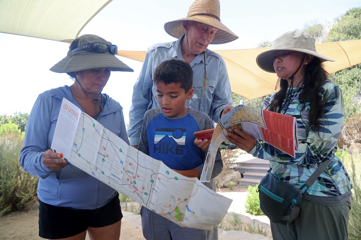 John Hunter helps hikers use a compass and trail map during a "Hiking 101" class Tuesday at Crystal Cove State Park.