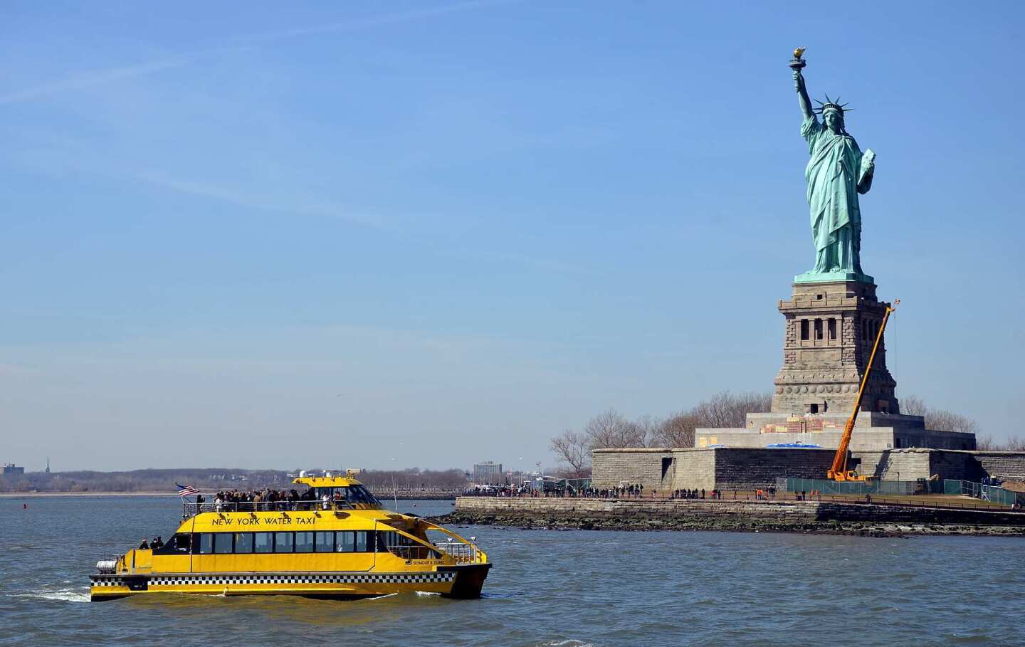 New York Water Taxi vessels cruise between the South Street Seaport and Pier 83 at West 42nd Street, passing the Statue of Liberty on the way.