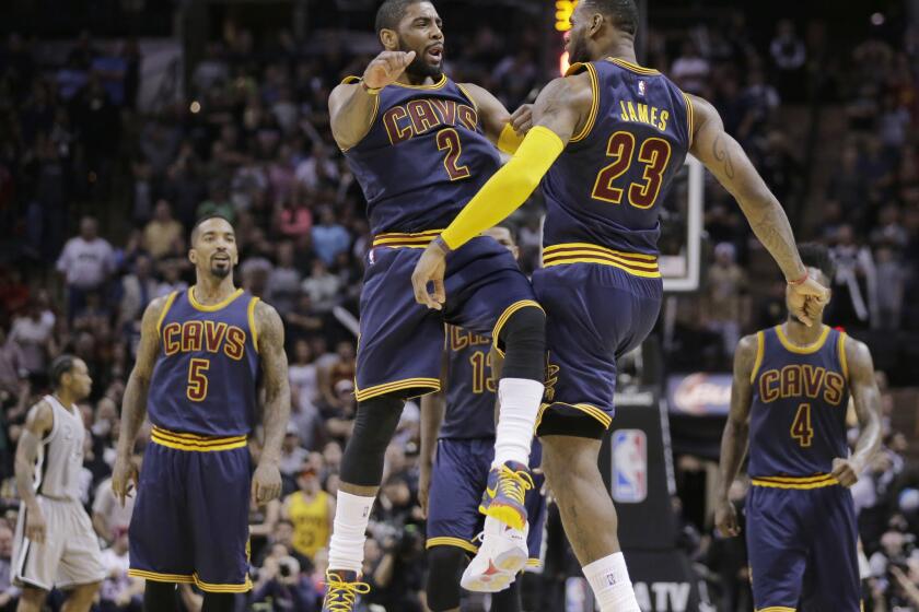 Cavaliers point guard Kyrie Irving and forward LeBron James celebrate during the Cavaliers' 128-125 overtime win over the Spurs.