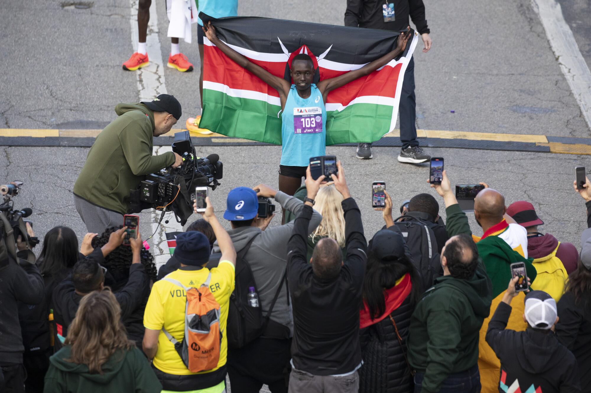 Delvine Meringor is photographed holding the flag of Kenya