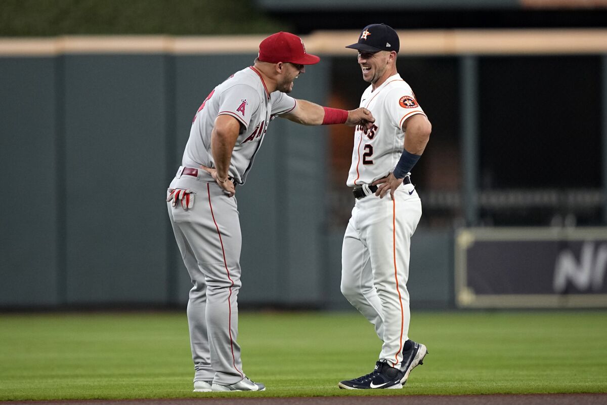 Houston Astros' Alex Bregman (2) talks with Los Angeles Angels' Mike Trout before a baseball game Saturday, July 2, 2022, in Houston. (AP Photo/David J. Phillip)