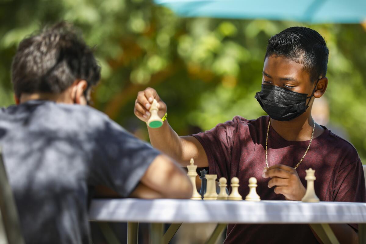  Jordan Smith (right), 10, plays chess at Waterfront Park against Garrett Loffler, 11.