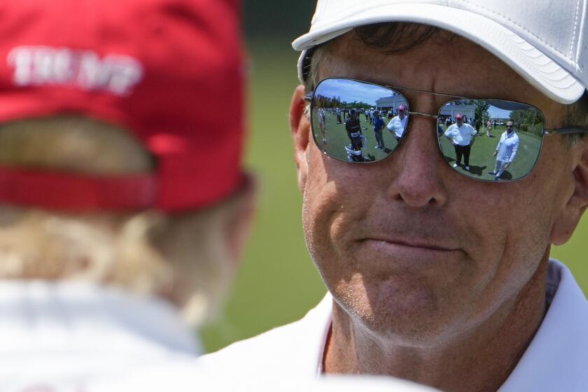 Former President Donald Trump talks with professional golfer Phil Mickelson before the second round of the LIV Golf at Trump National Golf Club, Saturday, May 27, 2023, in Sterling, Va. (AP Photo/Alex Brandon)