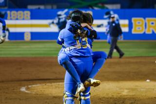 UCLA pitcher Taylor Tinsley jumps into the arms of catcher Sharlize Palacios.