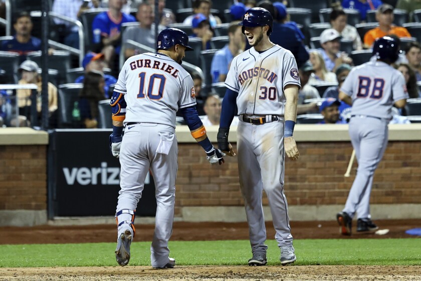 Houston Astros' Yuli Gurriel (10) celebrates with Astros' Kyle Tucker (30) after Gurriel hits a home run against New York Mets relief pitcher Chasen Shreve during the fifth inning of a baseball game, Tuesday, June 28, 2022, in New York. (AP Photo/Jessie Alcheh)
