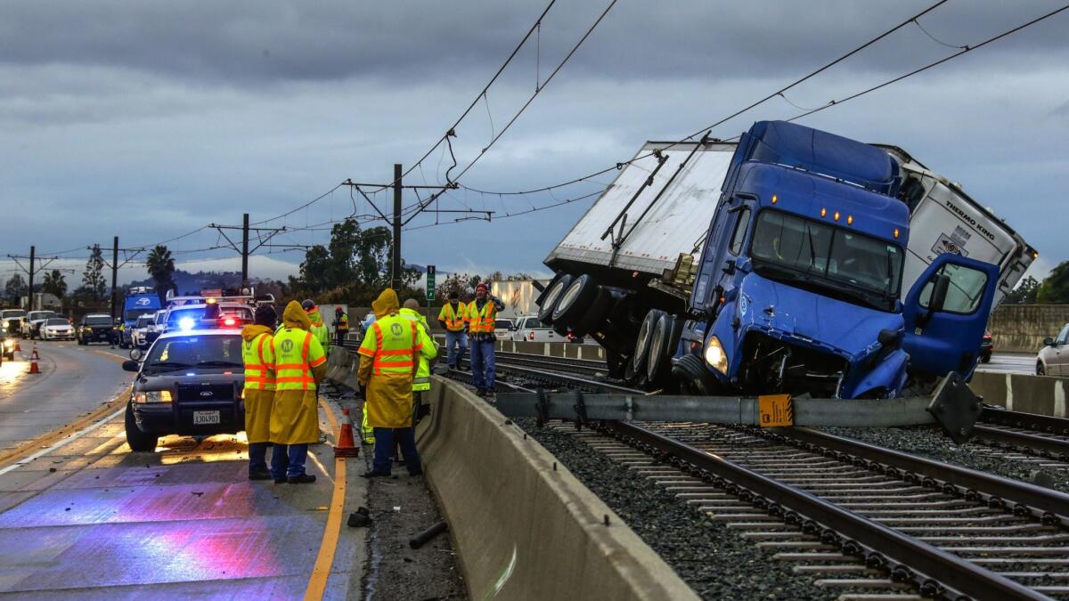 Work crews prepare to remove an overturned big rig on the eastbound 210 Freeway at Sierra Madre Boulevard that stopped Metro's Gold Line in 2016.