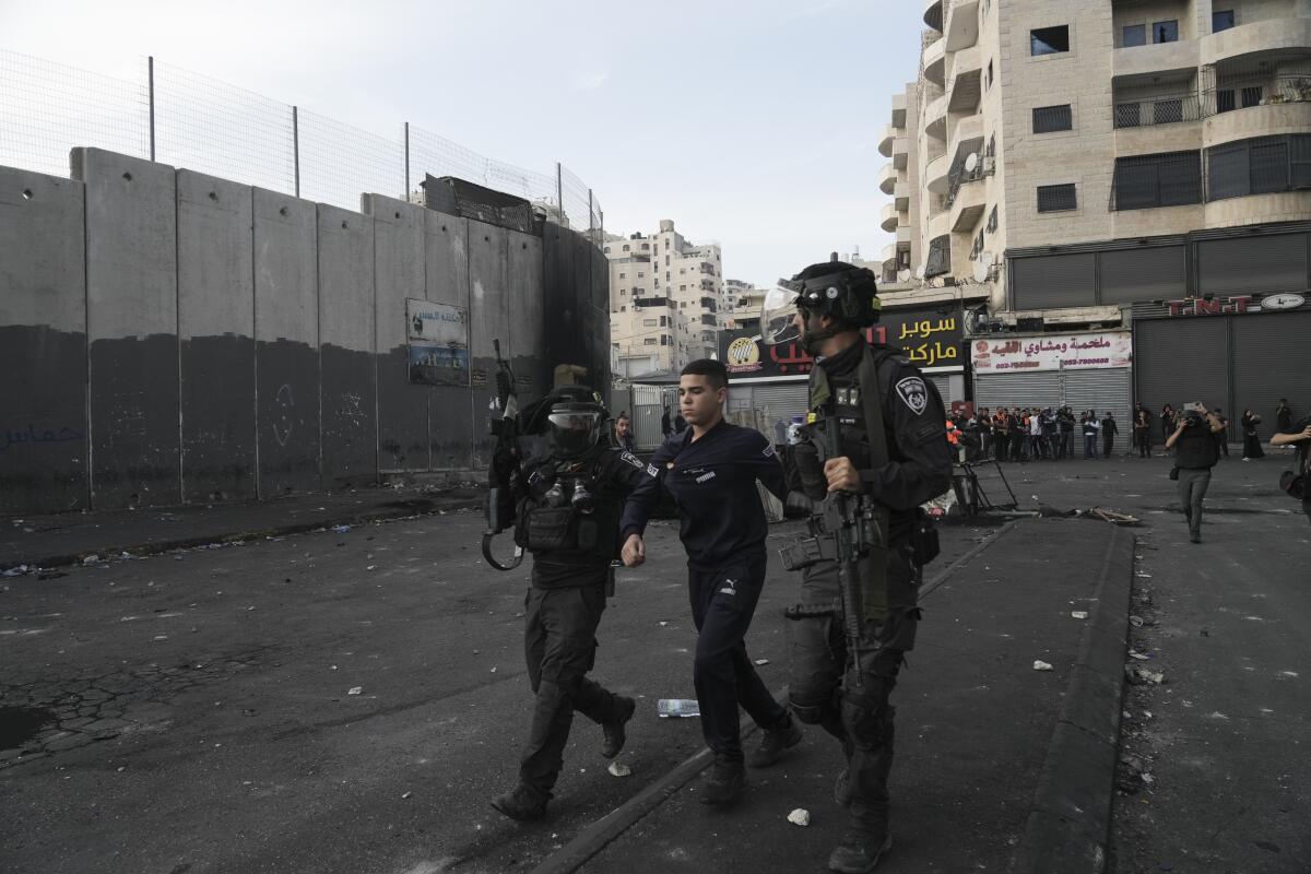 Israeli police arresting a Palestinian youth