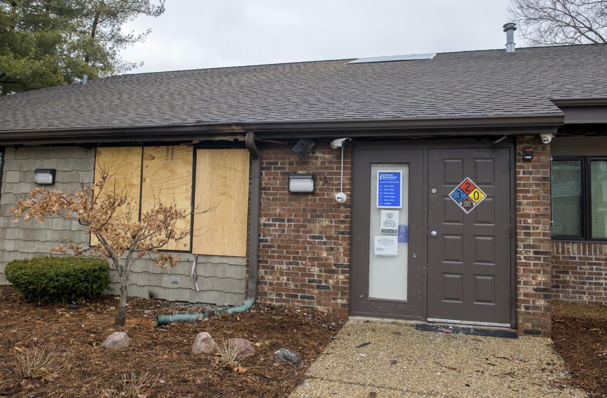 A front window is boarded up at a Planned Parenthood Health Center in Peoria, Ill.