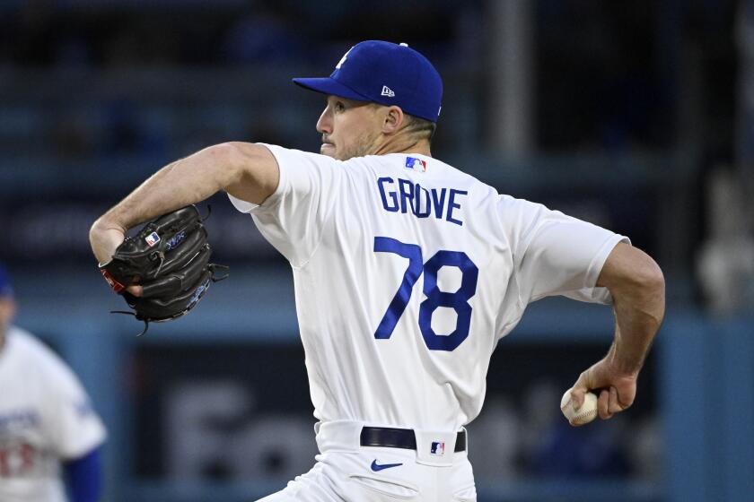 Los Angeles Dodgers starting pitcher Michael Grove throws to the plate during the first inning.