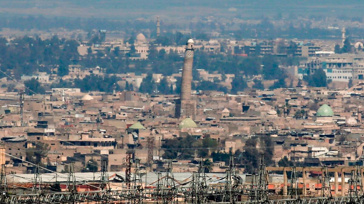 A picture taken on March 24, 2017, shows a general view of the skyline of west Mosul, Iraq, featuring the leaning minaret of the Great Nuri Mosque.
