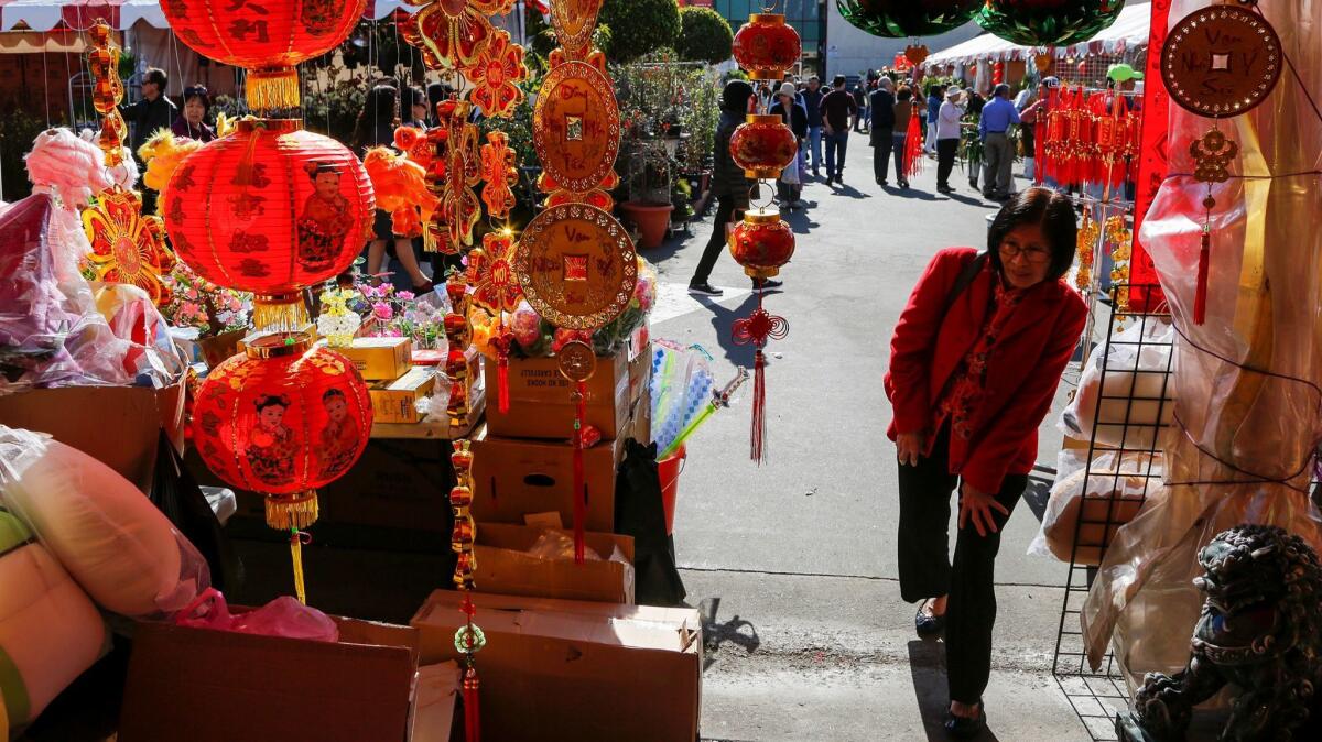 At the Flower Festival in front of the Asian Garden Mall in Westminster, vendors are selling their new year's decorations, flowers and traditional souvenirs.
