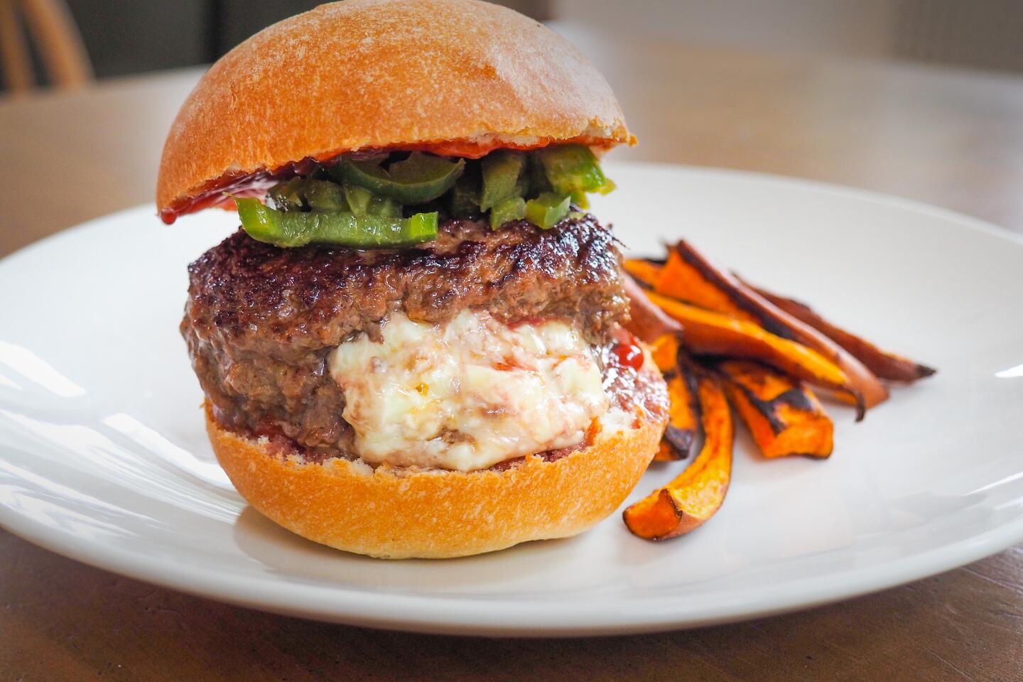 The EveryPlate jalapeno popper-stuffed burger with sweet potato fries.