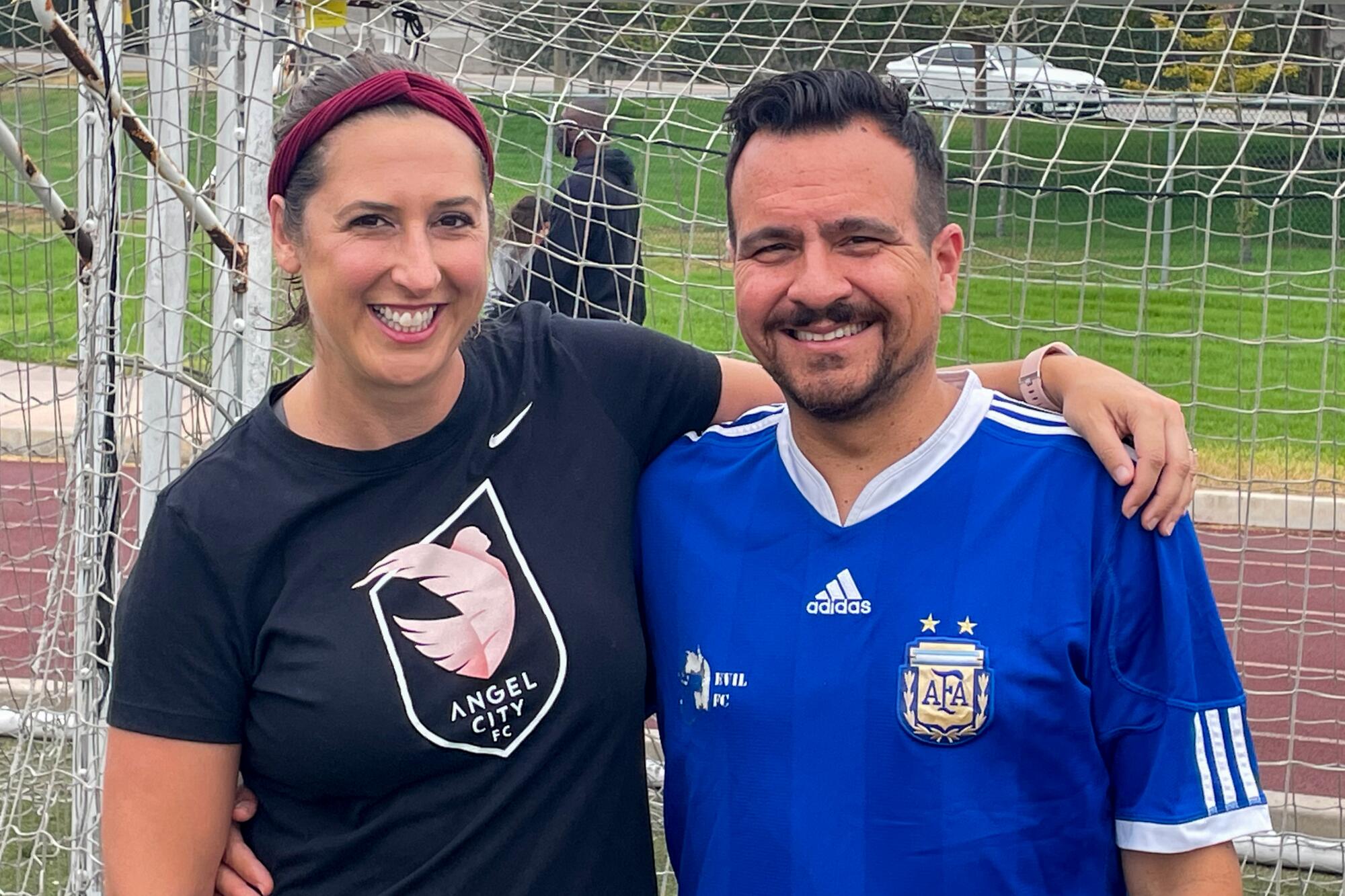 Two people on a soccer field.