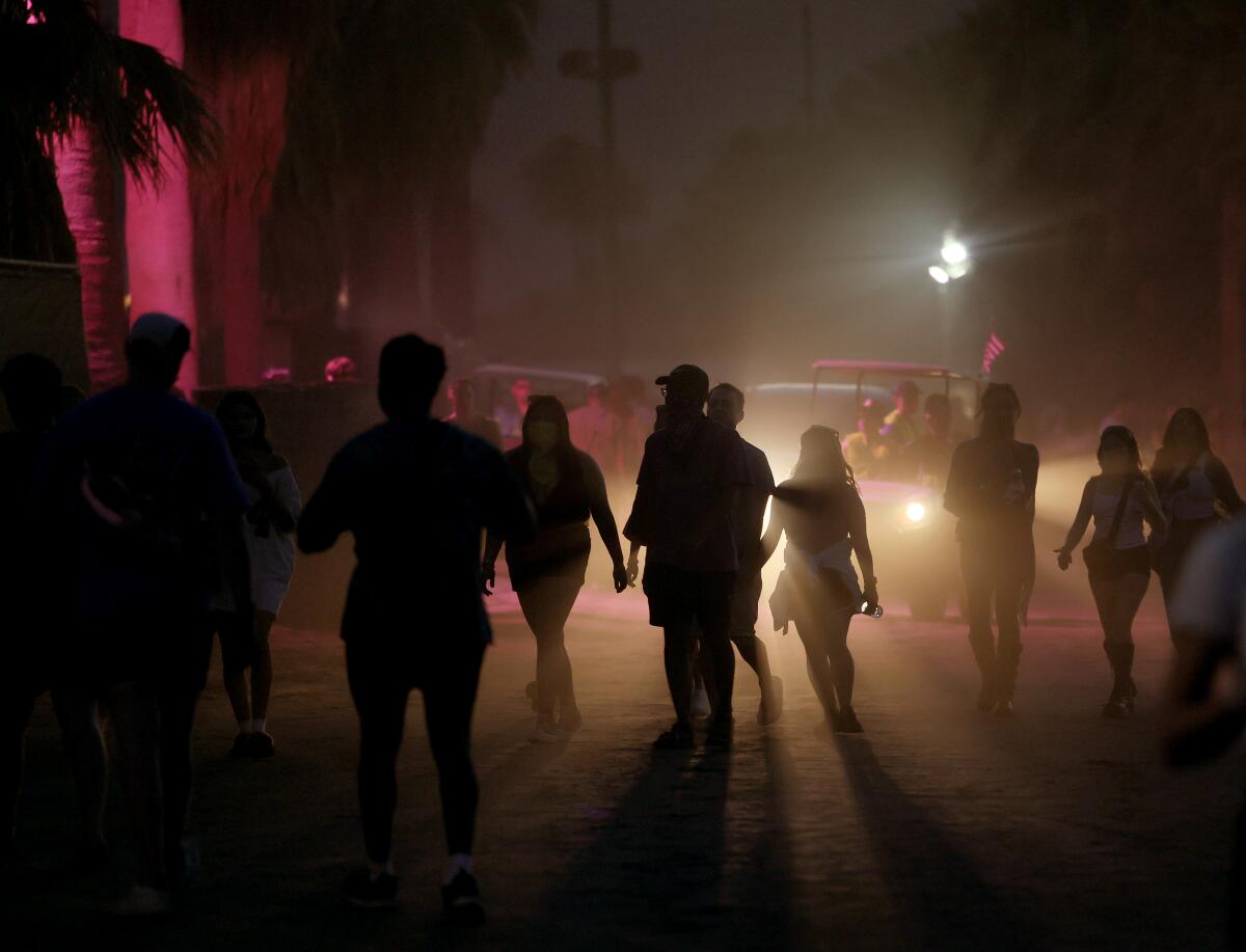 Campers are silhouetted arsenic they get connected the archetypal nighttime of Coachella successful Indio.
