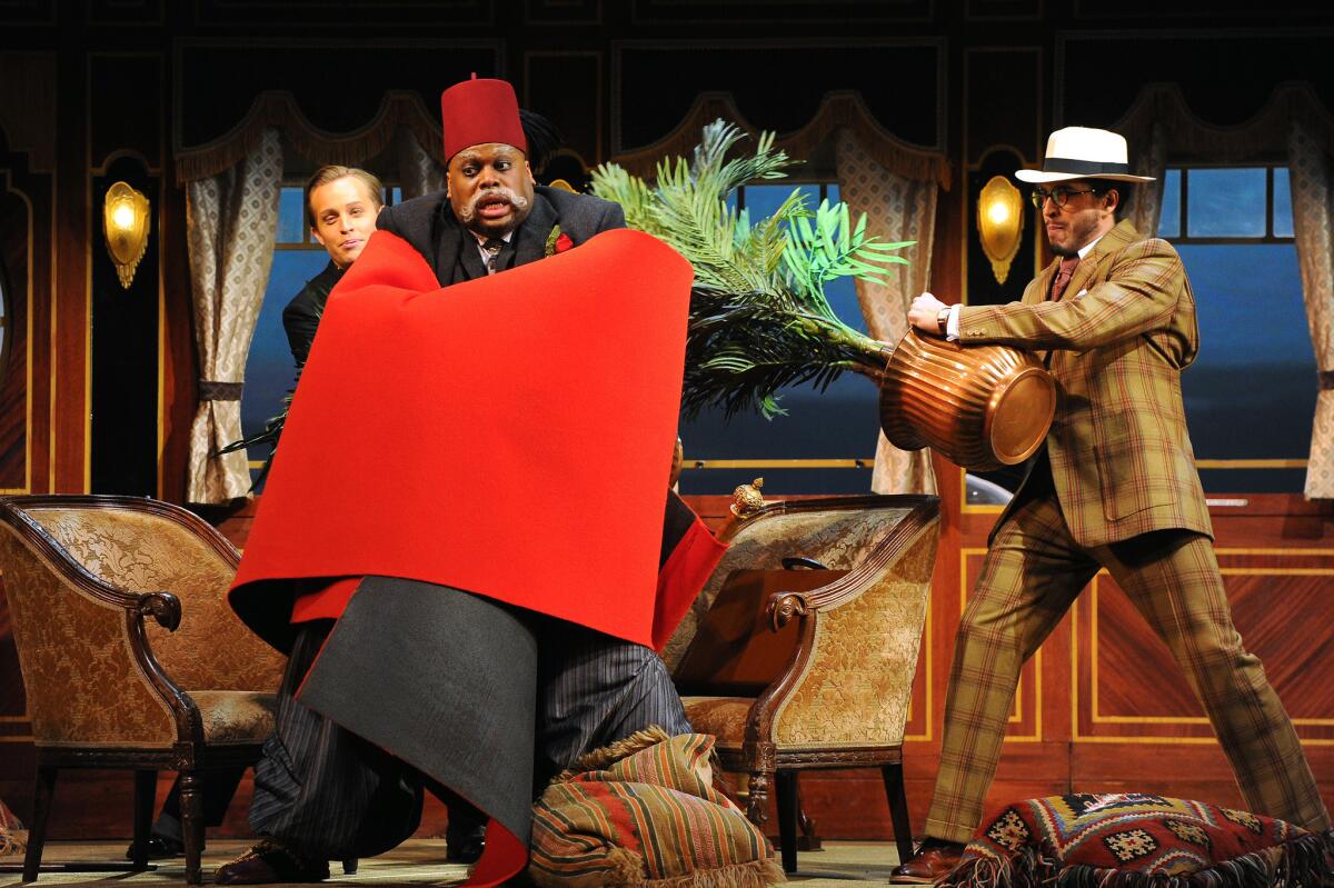 Morris Robinson, center, as Osmin, with Brenton Ryan, left, and Joel Prieto in the Los Angeles Opera production of Mozart's "The Abduction From the Seraglio" at the Dorothy Chandler Pavilion.