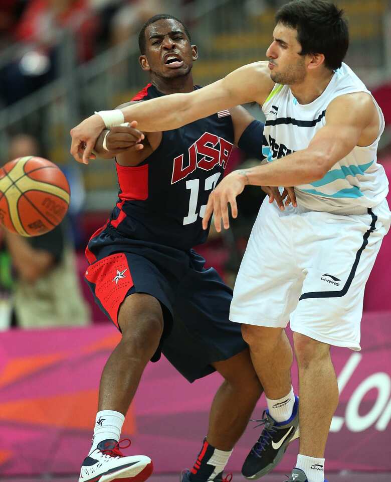 Team USA's Chris Paul, left, knocks the ball away from Argentina's Facundo Campazzo in the first half.