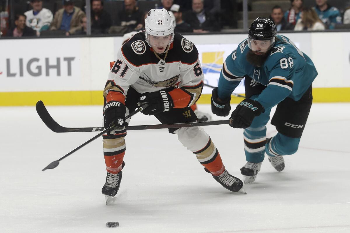 San Jose Sharks defenseman Brent Burns (88) reaches for the puck next to Ducks right wing Troy Terry (61) during the second period on Monday in San Jose.