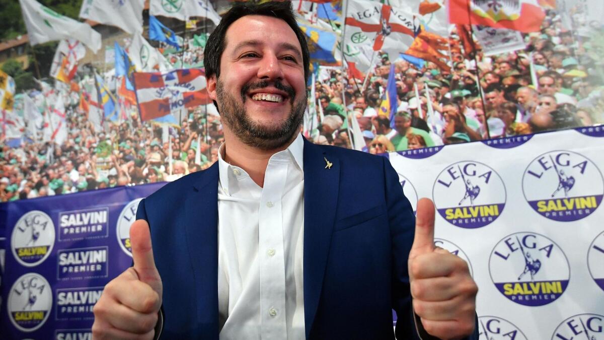 Matteo Salvini, leader of the right-wing, anti-immigrant League party, celebrates at a news conference on Monday.