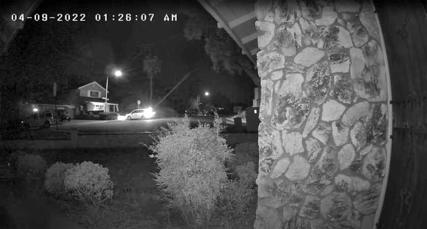 Video from a home security camera shows a white minivan pull into the driveway.