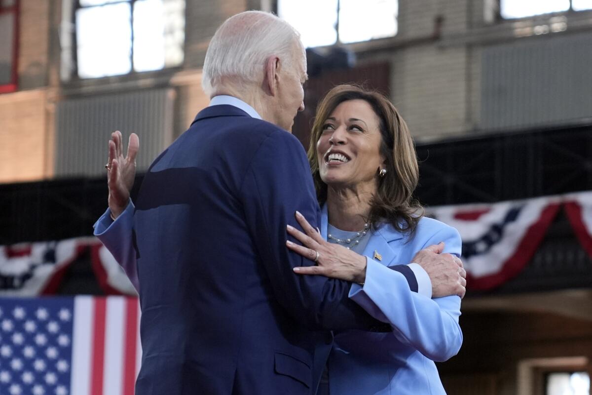 President Biden hugs Vice President Kamala Harris during a campaign event.