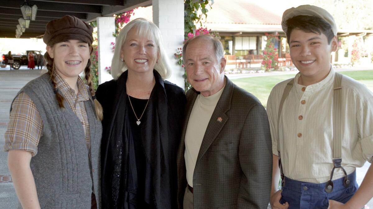 Providence High School performing arts students Liberty Vogler, left, and Sam Avila, right, welcoming former-Mayor Bill Wiggins and his wife Marilyn to last week's gala.