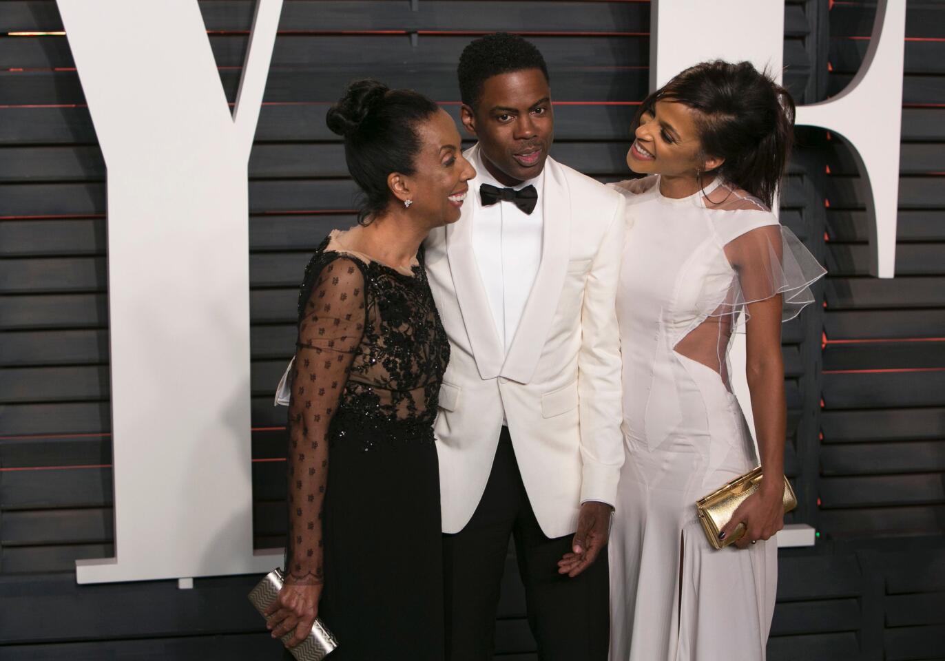 Oscars host Chris Rock poses with his wife, Malaak Compton Rock, right, and his mother, Rosalie Rock.