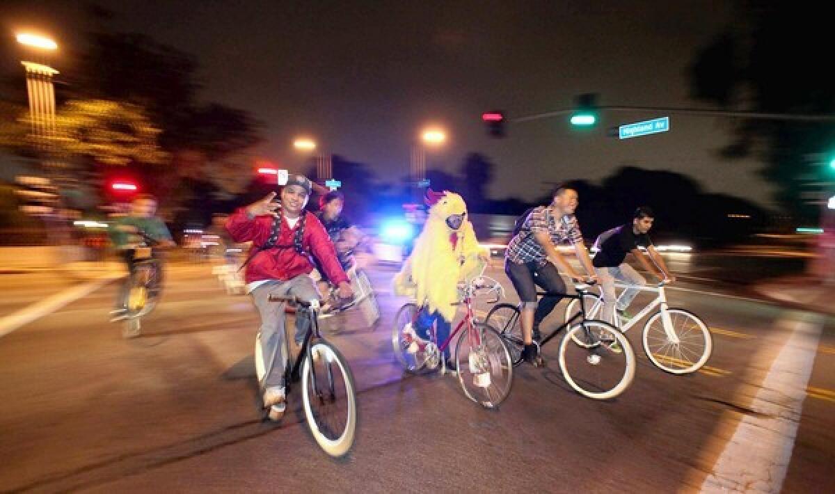ON THE MOVE: Fmly's Cameron Rath, in chicken costume, organizes the group's monthly bike ride-outdoor concert events.