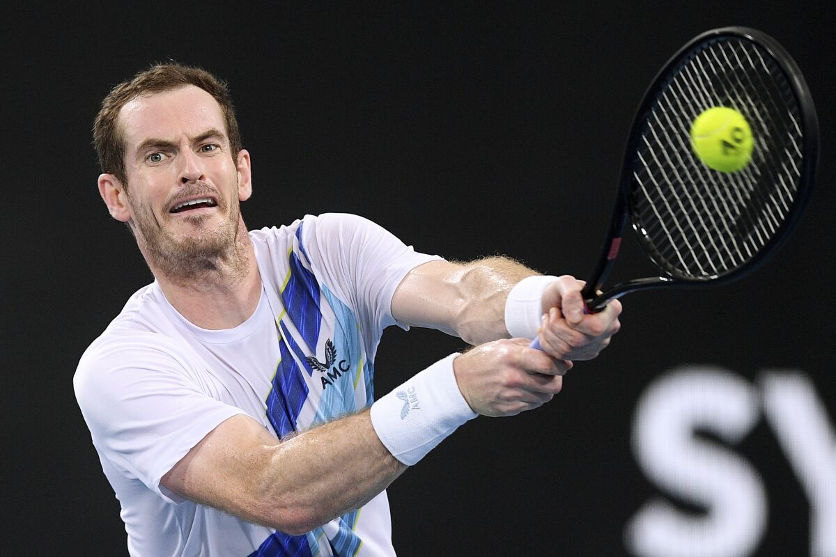 Britain's Andy Murray hits a backhand to Reilly Opelka of the United States during their match at the Sydney Tennis Classic in Sydney, Friday, Jan. 14, 2022. (Dan Himbrechts/AAP Image via AP)