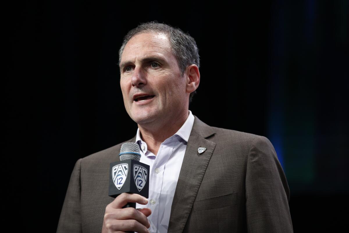 Pac-12 commissioner Larry Scott speaks at a news conference.