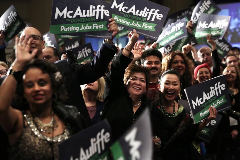 Supporters celebrate Democratic Virginia gubernatorial candidate Terry McAuliffe pulling ahead in election results.