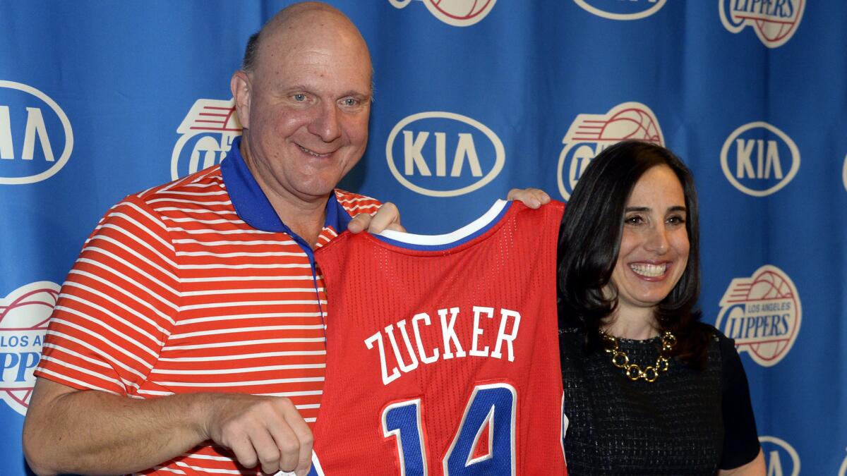 Clippers owner Steve Ballmer and Clippers President of Business Operations Gillian Zucker pose for photographs with her ceremonial jersey during Zucker's introductory news conference at Staples Center on Saturday.