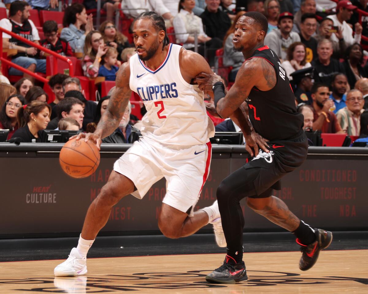 Clippers star Kawhi Leonard, left, drives past Miami Heat guard Terry Rozier during the Clippers' win.
