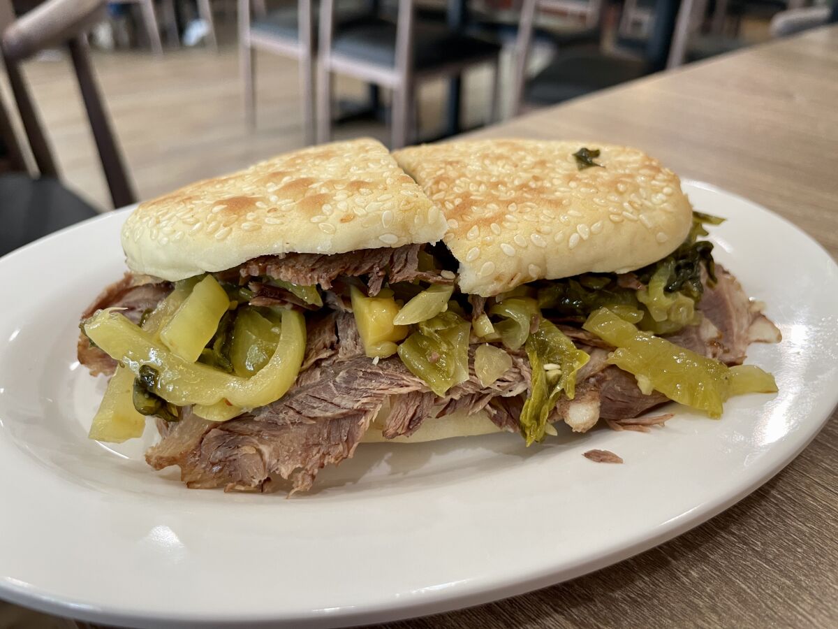 A biscuit packed with pickled greens and beef.
