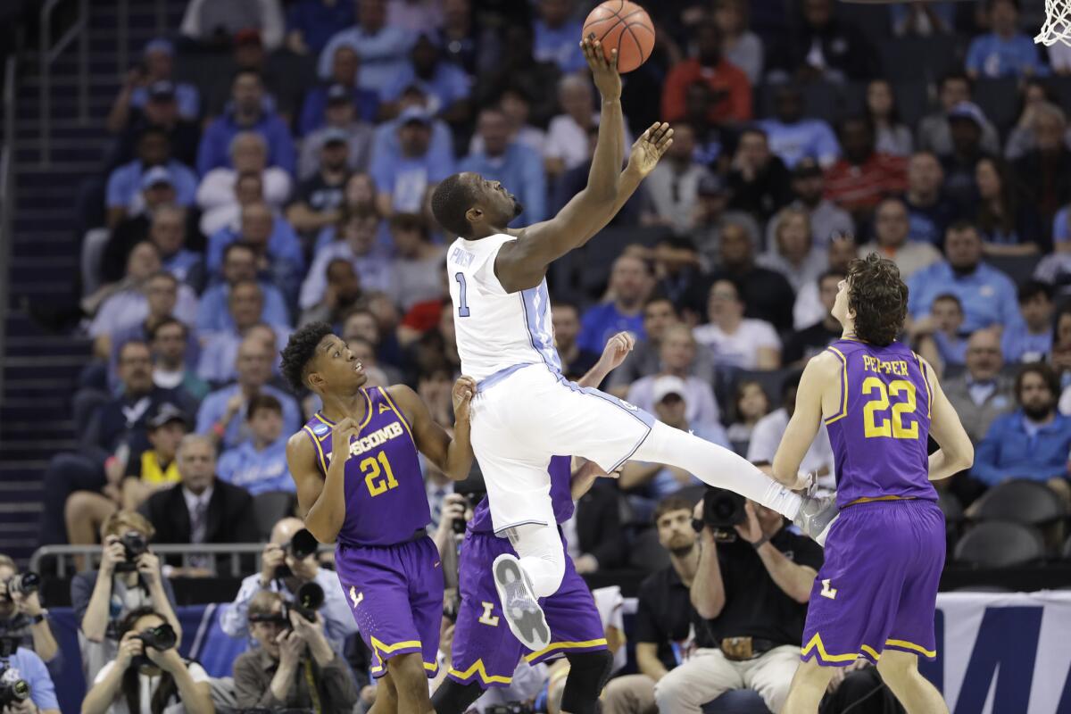 North Carolina's Theo Pinson shoots between Lipscomb defenders during the second half of an NCAA Tournament game on Friday.