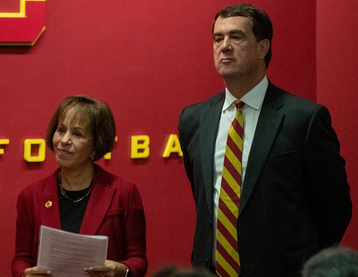 USC President Carol Folt, left, stands next to USC Athletic Director Mike Bohn during a news conference in November 2019.