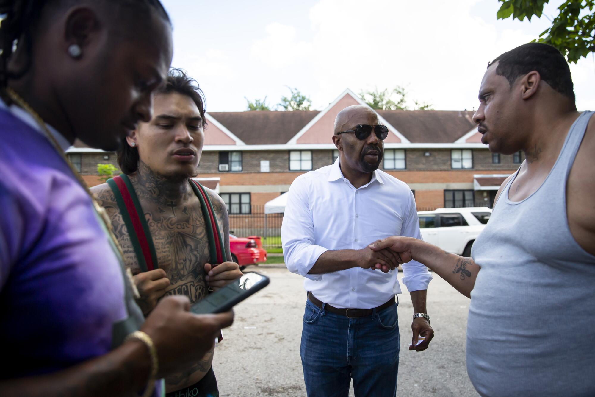 Daryl Washington, center, speaks with community members of Houston's Third Ward. 