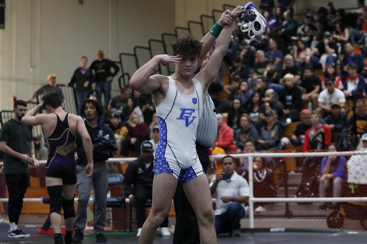 Fountain Valley's Max Wilner presses three fingers into his head after winning his third individual title in the CIF Southern Section Northern Division individual wrestling championships on Saturday at Marina High.