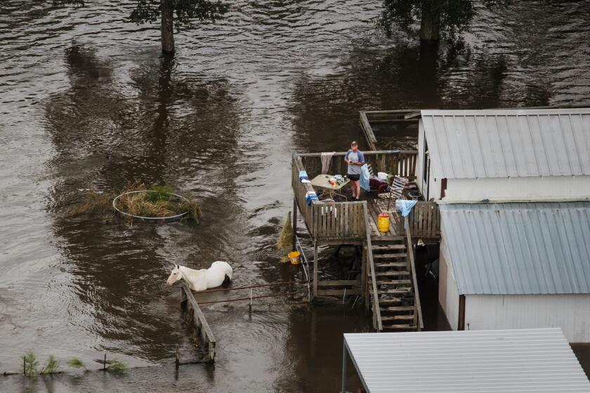 A man prepares dinner at his home surrounded by floodwater near Lumberton, Texas, on Aug. 31, 2017.