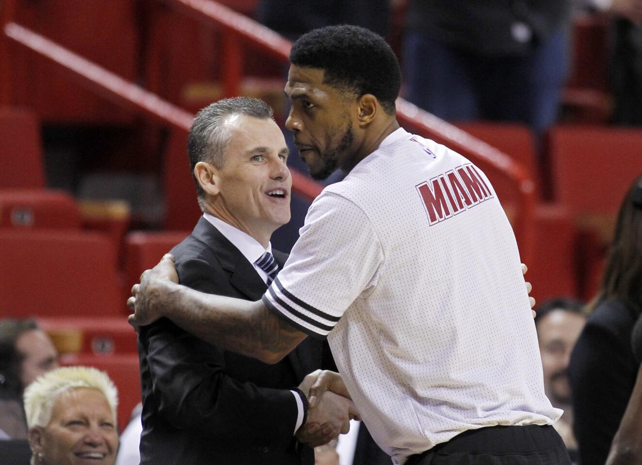 Oklahoma City Thunder head coach Billy Donovan greets Miami Heat forward Udonis Haslem (40), one of his former University of Florida players, before the teams met in an NBA basketball game, Thursday, Dec. 3, 2015, in Miami. (AP Photo/Joe Skipper)