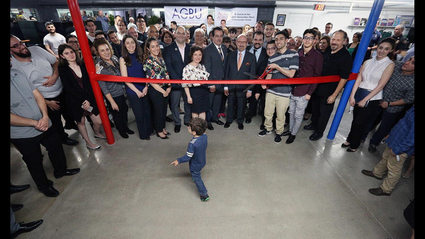 As a ribbon cutting to commemorate the new space is beginning to take shape, a small boy runs across the open space at an open house for the new facilities for AGBU GenNext in available space in the YWCA in Glendale on Thursday, March 29, 2018.ABGU GenNext is an at-risk youth mentoring service that was established 20 years ago as part of the non-profit Armenian General Benevolent Union.