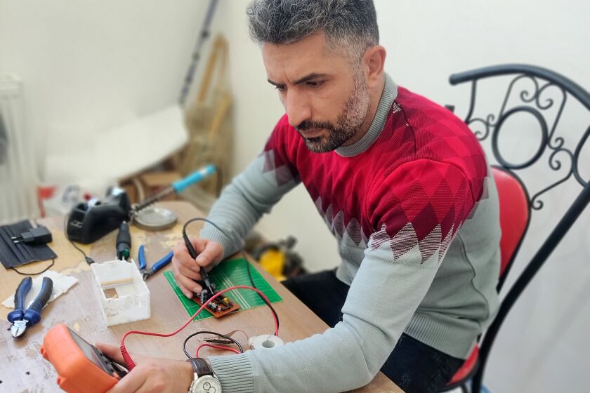 Vahid Muharrami, 37, works on a training device he invented to help people learning karate.
